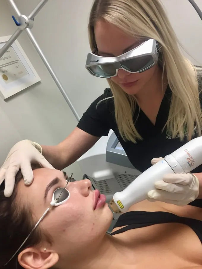 Provider performing a laser skin treatment with protective eyewear